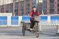 Female migrant worker on a freight bike, Beijing, China Royalty Free Stock Photo